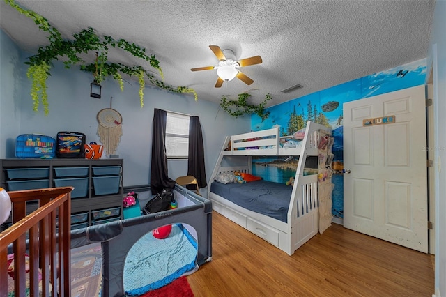 408 Etheredge St, Bushnell, FL 33513 - bedroom featuring a textured ceiling, wood finished floors, and ceiling fan