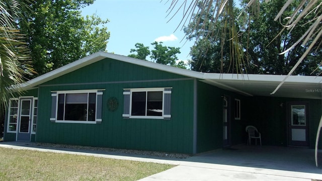 9880 SW 101st Pl, Ocala, FL 34481 - view of property exterior with driveway and an attached carport