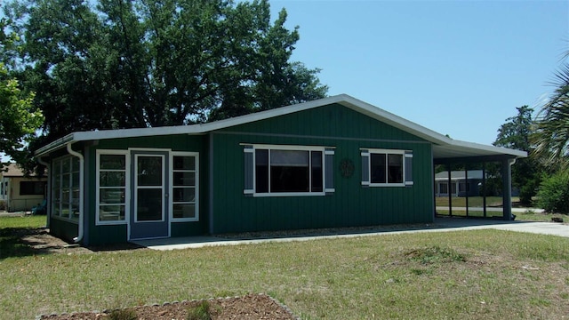 9880 SW 101st Pl, Ocala, FL 34481 - view of home's exterior with a yard and an attached carport