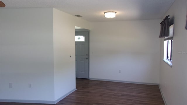 9880 SW 101st Pl, Ocala, FL 34481 - empty room with baseboards, dark wood finished floors, and visible vents