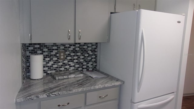 9880 SW 101st Pl, Ocala, FL 34481 - room details with freestanding refrigerator, gray cabinets, and tasteful backsplash