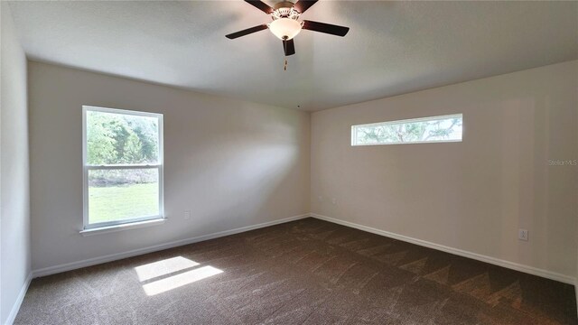 15407 SW 59th Avenue Rd, Ocala, FL 34473 - spare room featuring dark carpet, baseboards, and ceiling fan