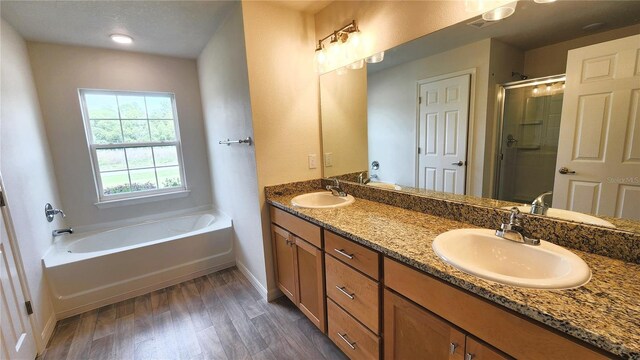 15407 SW 59th Avenue Rd, Ocala, FL 34473 - full bath with a sink, a bath, wood finished floors, and a stall shower