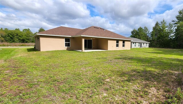 15407 SW 59th Avenue Rd, Ocala, FL 34473 - rear view of property featuring a patio area, stucco siding, and a yard