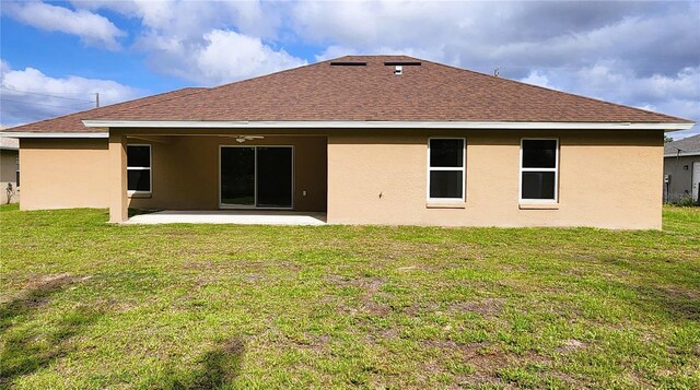 15407 SW 59th Avenue Rd, Ocala, FL 34473 - back of property with stucco siding, a shingled roof, a ceiling fan, a patio area, and a yard