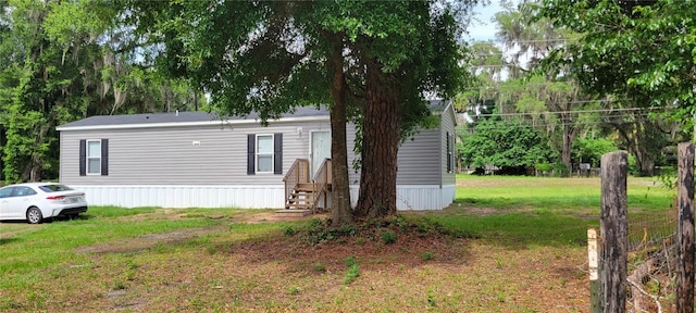 15951 NW 44th Avenue Rd, Reddick, FL 32686 - view of property exterior with a lawn and entry steps