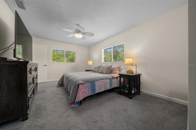 bedroom featuring carpet, baseboards, a ceiling fan, and a textured ceiling