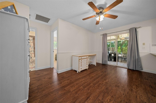 empty room featuring wood finished floors, baseboards, a ceiling fan, and a textured ceiling