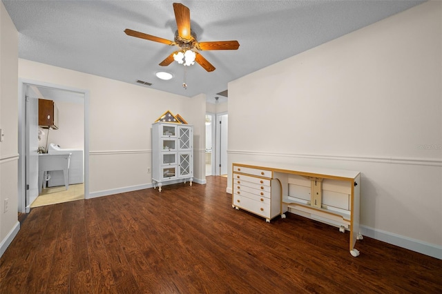 spare room featuring ceiling fan, wood finished floors, baseboards, and a sink
