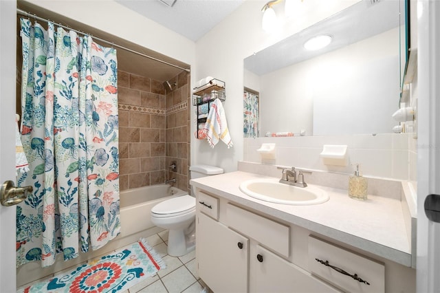full bathroom featuring tile patterned flooring, shower / bath combo with shower curtain, vanity, and toilet
