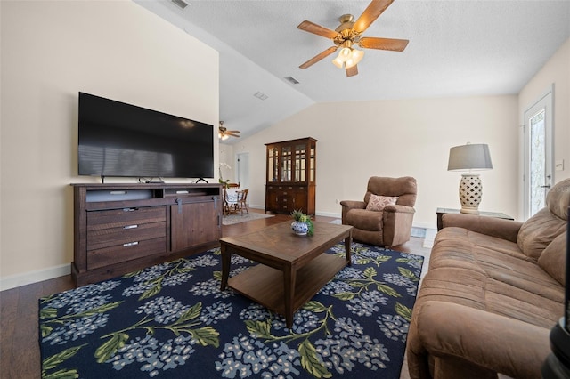 living room with a ceiling fan, vaulted ceiling, dark wood-style floors, and baseboards
