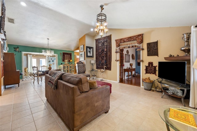 living area with a chandelier, vaulted ceiling, and baseboards