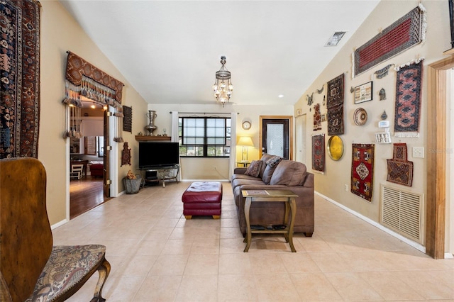 living area featuring lofted ceiling, a chandelier, light tile patterned floors, and baseboards
