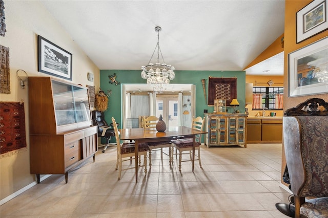 dining room featuring a chandelier, light tile patterned flooring, and lofted ceiling