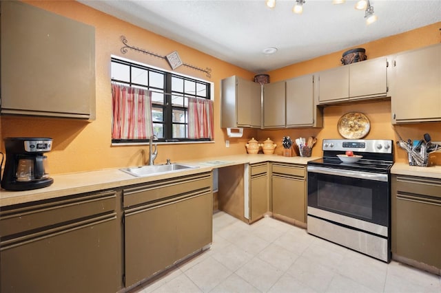 kitchen featuring electric range, a sink, and light countertops