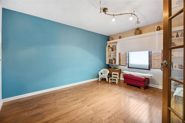 sitting room with wood finished floors and baseboards