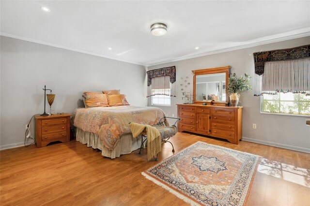 bedroom with ornamental molding, light wood-type flooring, recessed lighting, and baseboards