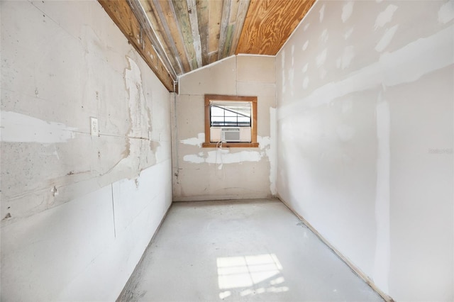unfurnished room featuring vaulted ceiling and cooling unit