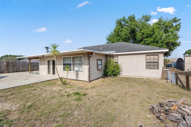 rear view of property featuring a patio area and driveway