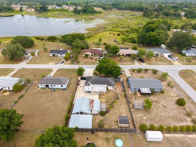 aerial overview of property's location with a large body of water and nearby suburban area