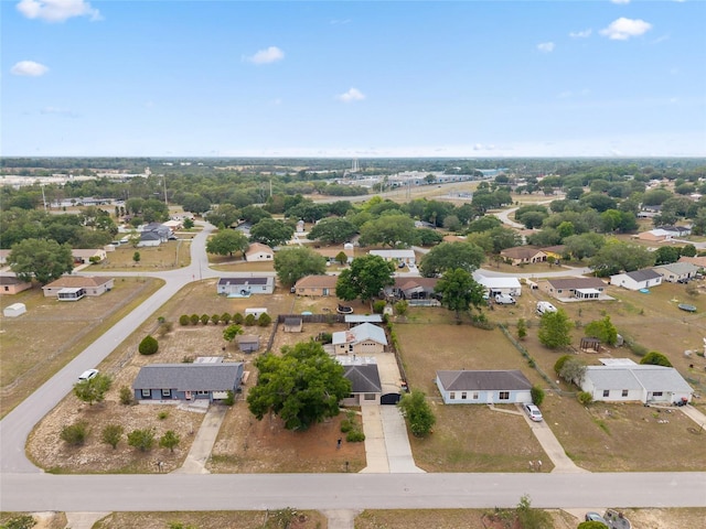 aerial view of property and surrounding area featuring nearby suburban area