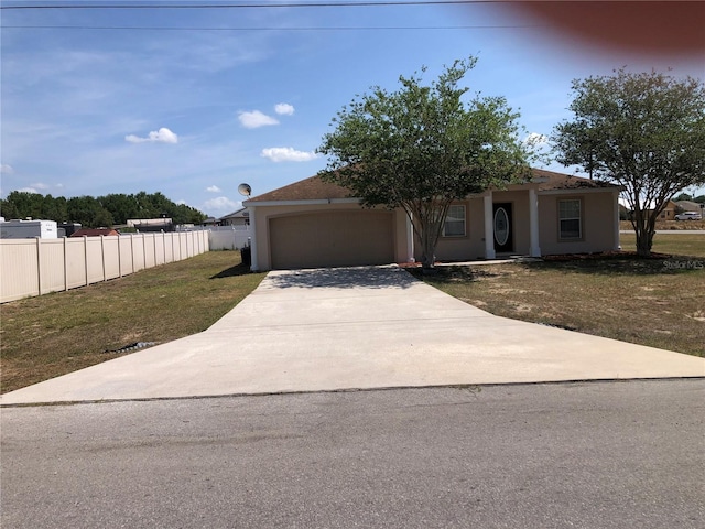 view of front facade with a garage, fence, a front lawn, concrete driveway, and stucco siding