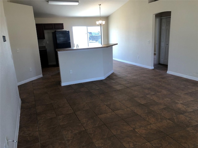 kitchen with baseboards, a chandelier, and pendant lighting
