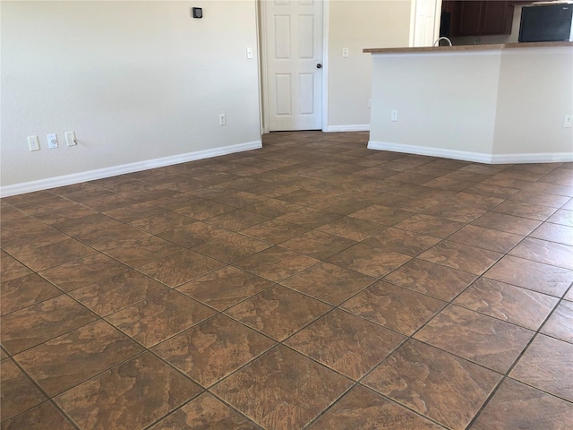 unfurnished living room featuring baseboards