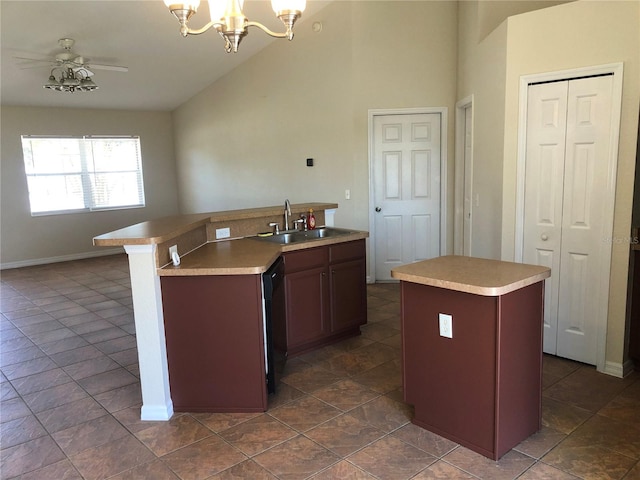 kitchen featuring a sink, ceiling fan with notable chandelier, black dishwasher, and a center island with sink