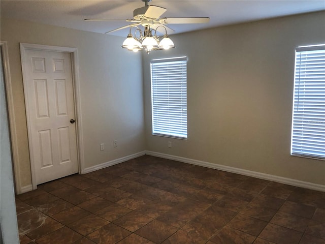 empty room featuring baseboards and ceiling fan