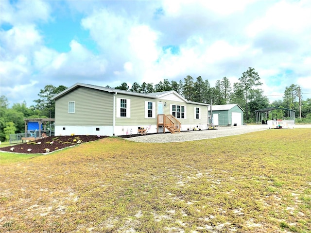 7030 SE 120th Ct, Morriston, FL 32668 - manufactured / mobile home featuring crawl space, an outbuilding, and a front yard