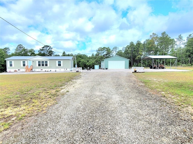 7030 SE 120th Ct, Morriston, FL 32668 - manufactured / mobile home with a detached garage, an outdoor structure, driveway, and a front yard