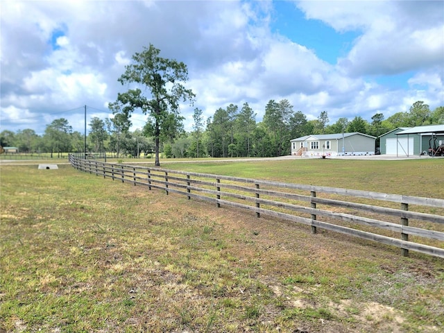 7030 SE 120th Ct, Morriston, FL 32668 - view of yard featuring a garage, fence, and a rural view