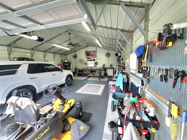 7030 SE 120th Ct, Morriston, FL 32668 - garage with metal wall, a garage door opener, ceiling fan, and a workshop area