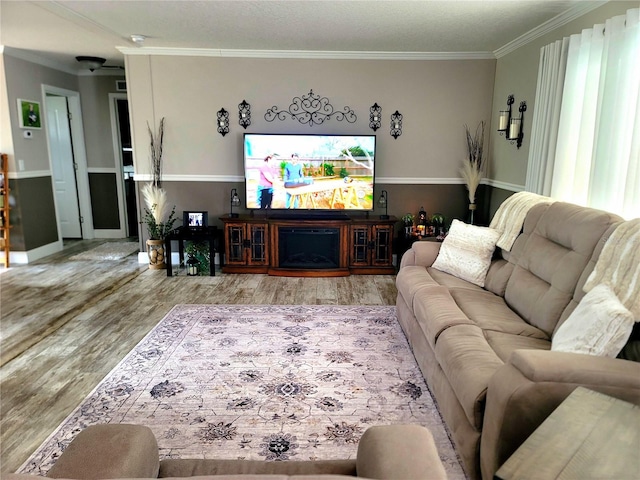 7030 SE 120th Ct, Morriston, FL 32668 - living area featuring ornamental molding, wood finished floors, and a fireplace