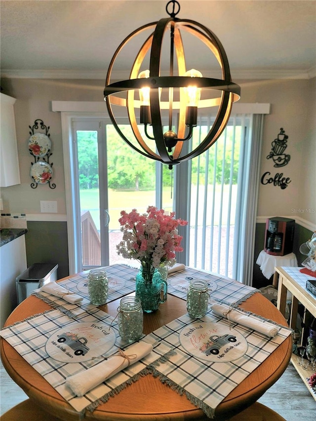 7030 SE 120th Ct, Morriston, FL 32668 - dining room featuring an inviting chandelier, ornamental molding, and wood finished floors