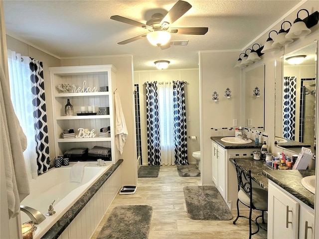 7030 SE 120th Ct, Morriston, FL 32668 - full bathroom featuring wood finished floors, a ceiling fan, a textured ceiling, and a wealth of natural light