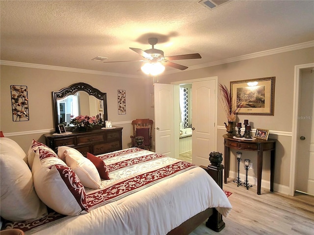 7030 SE 120th Ct, Morriston, FL 32668 - bedroom featuring a ceiling fan, a textured ceiling, visible vents, light wood finished floors, and ornamental molding