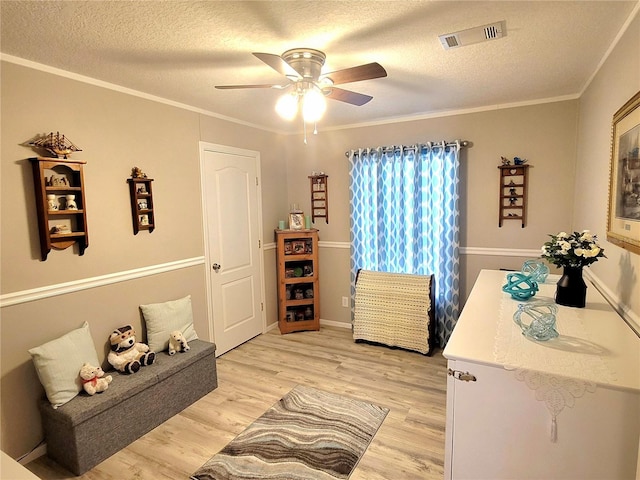 7030 SE 120th Ct, Morriston, FL 32668 - bedroom featuring visible vents, ornamental molding, light wood-style flooring, and a textured ceiling