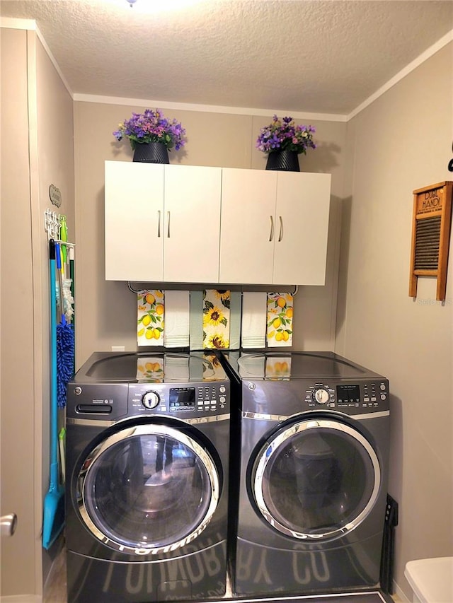 7030 SE 120th Ct, Morriston, FL 32668 - washroom with a textured ceiling, ornamental molding, cabinet space, and washing machine and clothes dryer