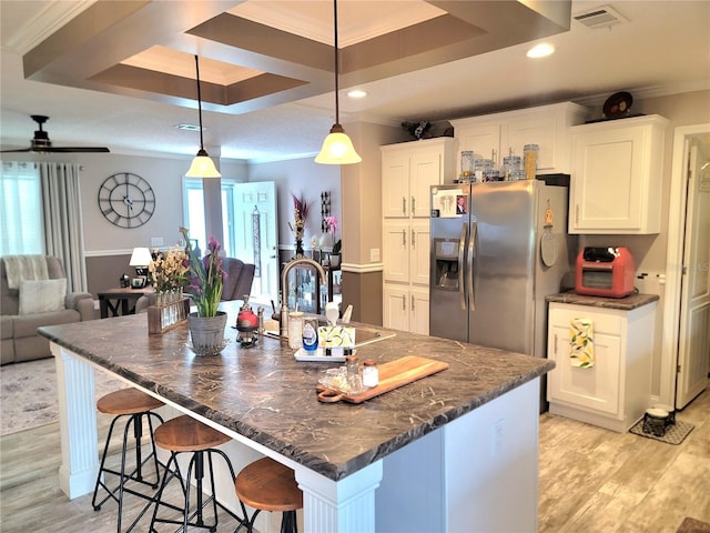 7030 SE 120th Ct, Morriston, FL 32668 - kitchen featuring crown molding, a sink, stainless steel fridge with ice dispenser, light wood-type flooring, and visible vents