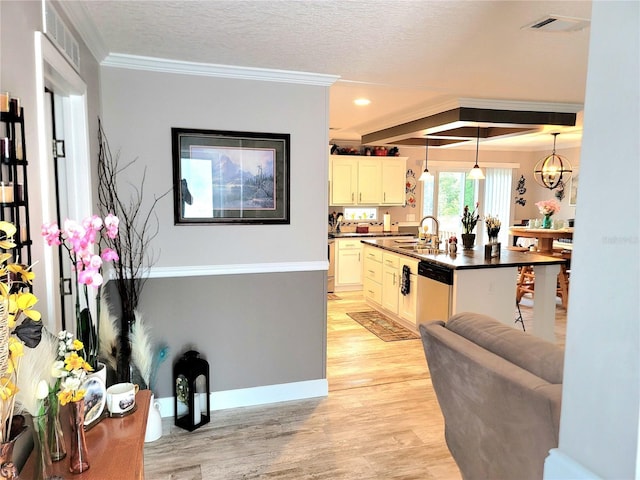 7030 SE 120th Ct, Morriston, FL 32668 - kitchen with dark countertops, dishwasher, a sink, light wood-style floors, and ornamental molding