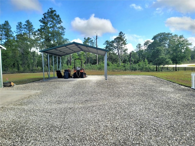 7030 SE 120th Ct, Morriston, FL 32668 - view of community with a lawn, a detached carport, fence, and gravel driveway