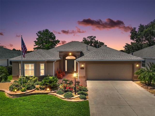 8545 SE 168th Kittredge Loop, The Villages, FL 32162 - ranch-style house with a shingled roof, concrete driveway, an attached garage, stucco siding, and a front yard