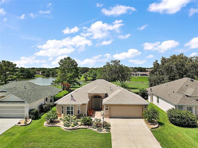 8545 SE 168th Kittredge Loop, The Villages, FL 32162 - view of front of house featuring a garage, concrete driveway, stucco siding, a front lawn, and a water view
