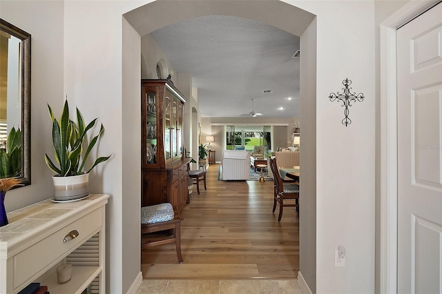 8545 SE 168th Kittredge Loop, The Villages, FL 32162 - corridor with arched walkways and light wood-style floors