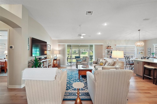 8545 SE 168th Kittredge Loop, The Villages, FL 32162 - living area with ceiling fan, light wood-style floors, vaulted ceiling, arched walkways, and recessed lighting