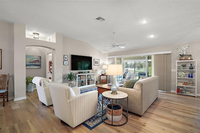 8545 SE 168th Kittredge Loop, The Villages, FL 32162 - living room with arched walkways, vaulted ceiling, ceiling fan, light wood-style floors, and recessed lighting
