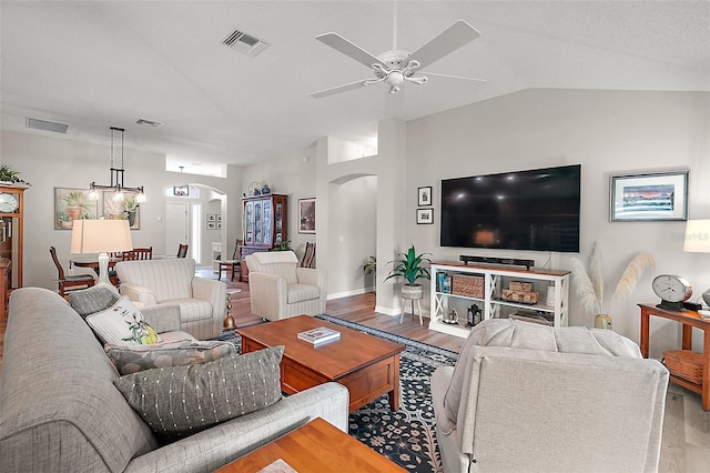 8545 SE 168th Kittredge Loop, The Villages, FL 32162 - living room featuring arched walkways, wood finished floors, lofted ceiling, and ceiling fan