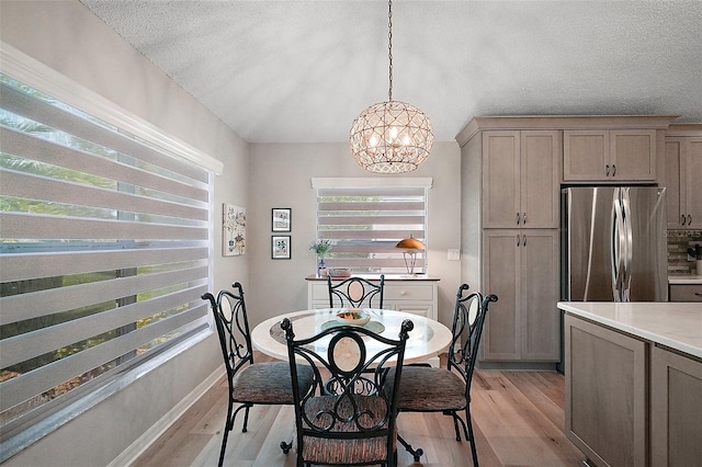 8545 SE 168th Kittredge Loop, The Villages, FL 32162 - dining area with a chandelier, light wood finished floors, and a textured ceiling